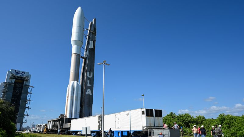 The rocket standing vertically from the ULA assembly building onto the launchpad