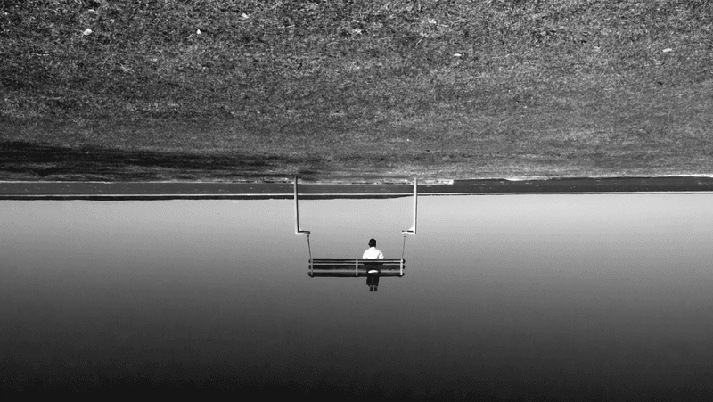 man sitting upside down on bench