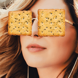A woman wearing crackers instead of glasses.