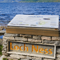 a sign for loch ness in front of the loch