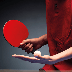 close up on hand shake between robot and human wearing a checked shirt; right panel shows a person in a red shirt getting ready to serve in a table tennis match
