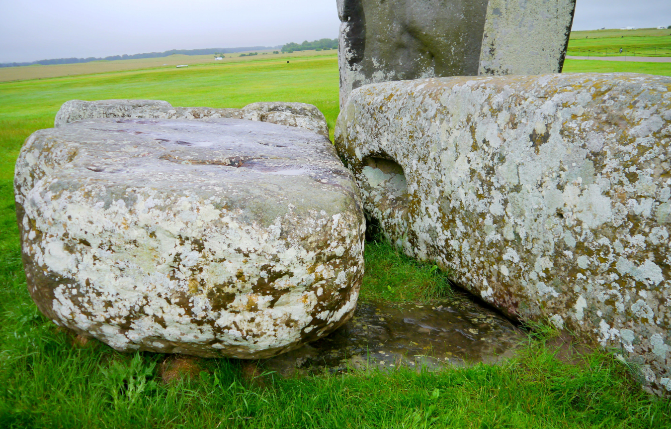 Stonehenge Altar Stone, seen here underneath two bigger Sarsen stones. Stonehenge Altar Stone, seen here underneath two bigger Sarsen stones.