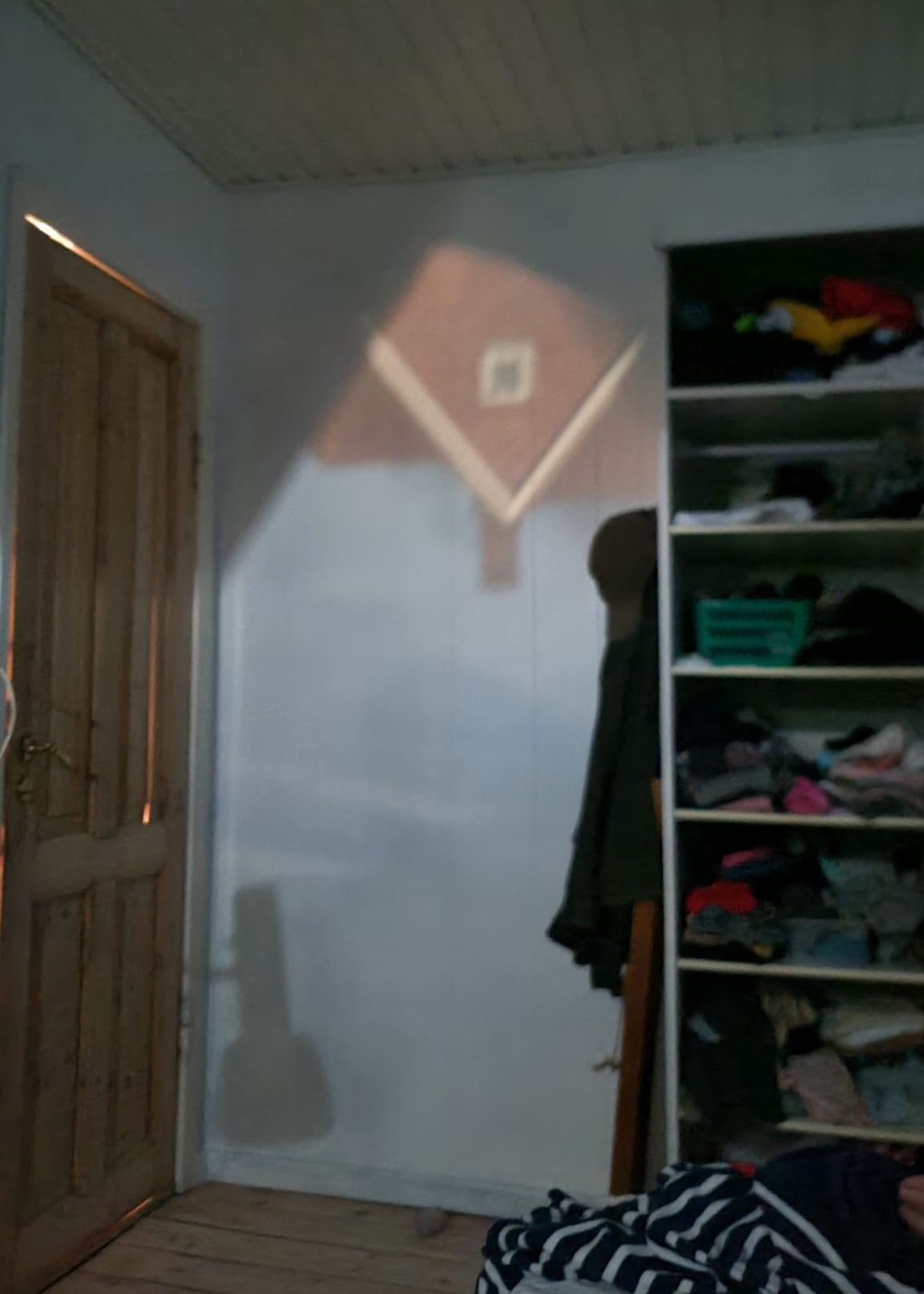 A house projected onto a bedroom wall. A house projected onto a bedroom wall.